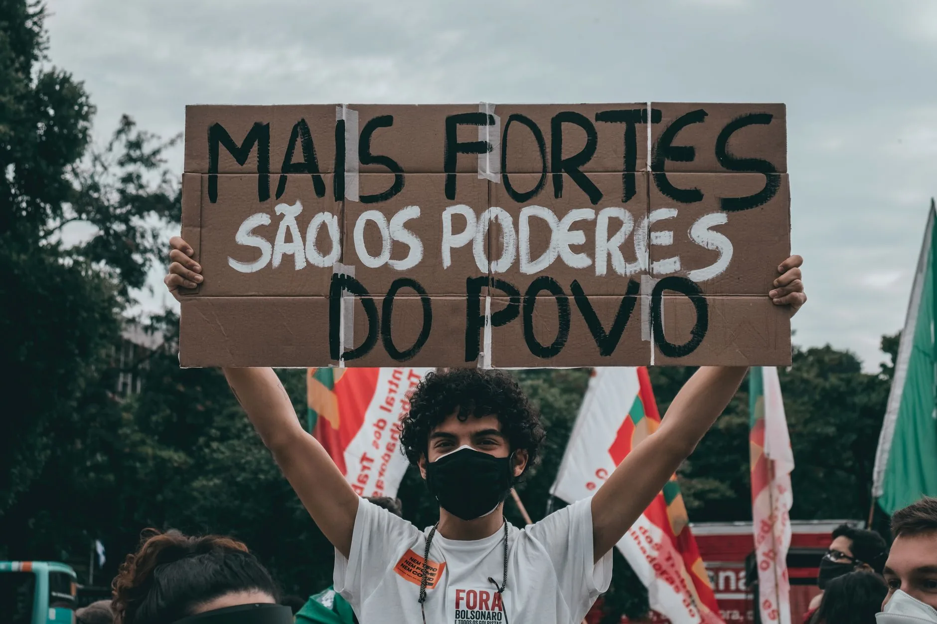Dimly lit, empty concrete cell in political detention center during pandemic, muted colors.